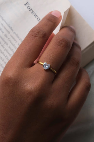 a close up of a person's hand holding a book