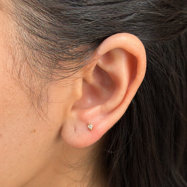 Close-up of an ear with a diamond stud earring